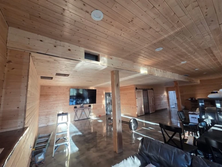 Heartland’s tongue-and-groove ceiling and timber support post in a wood-paneled interior